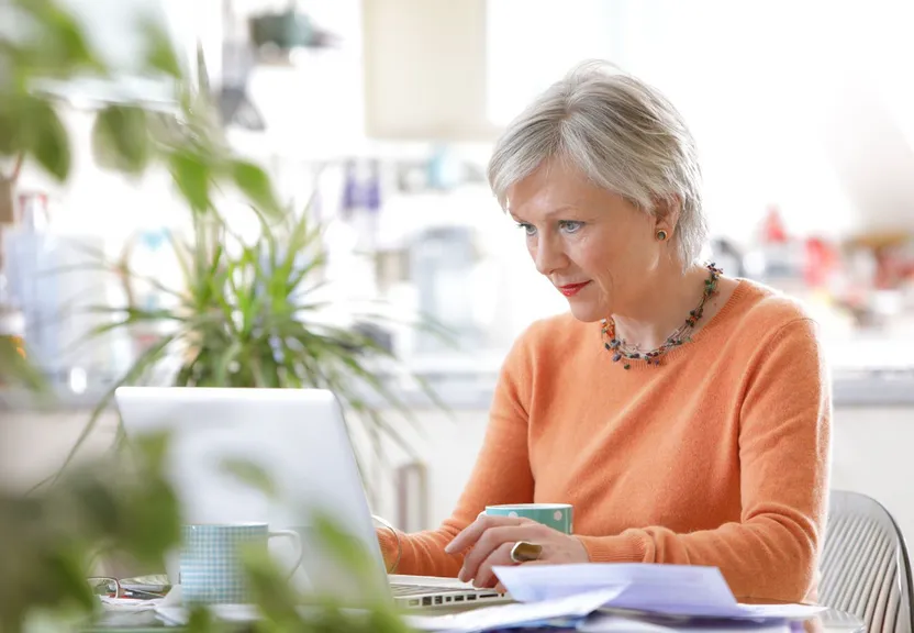 a woman sitting in front of a laptop computer