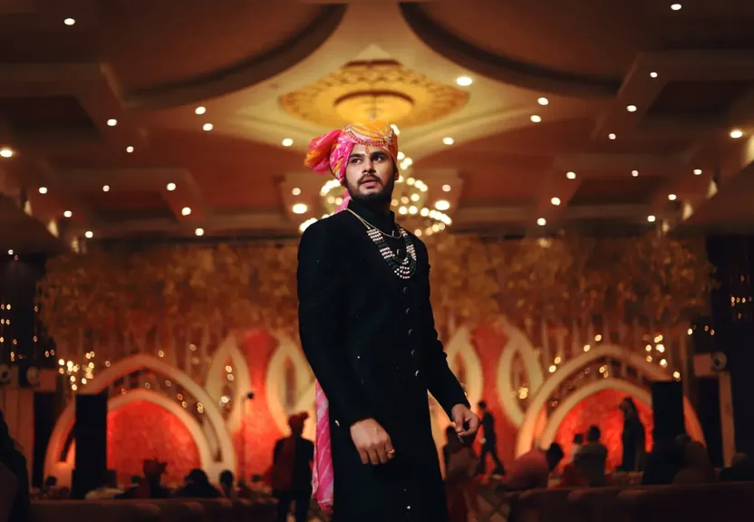 a man in a tuxedo standing in a room