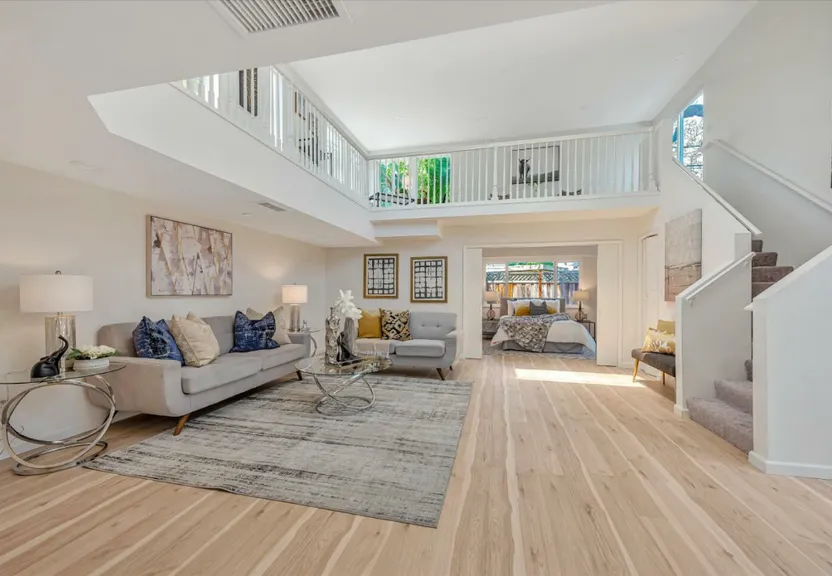 a living room filled with furniture and a staircase