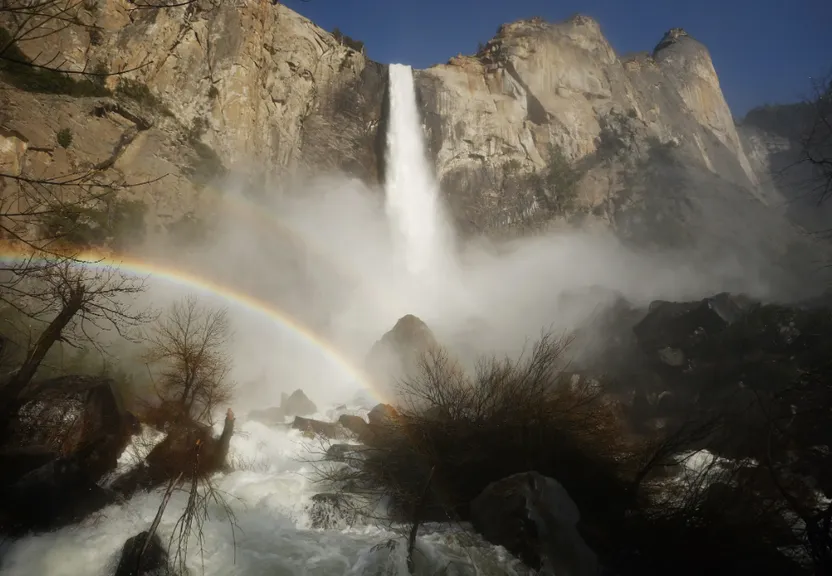 a waterfall with a rainbow in the middle of it