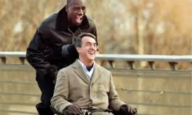 a man in a wheel chair being pushed by another man