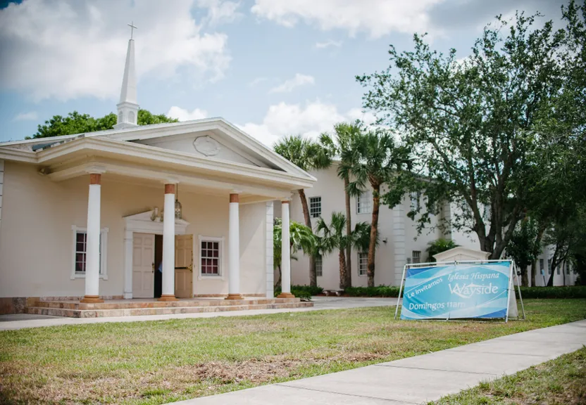 a church with a sign in front of it