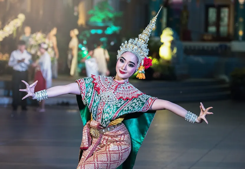 a woman in a green and red costume is dancing