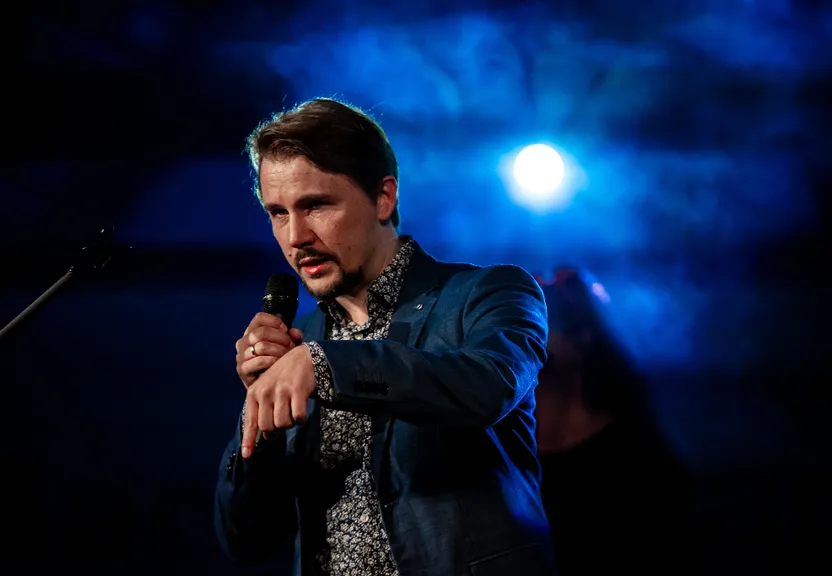 a man standing in front of a microphone