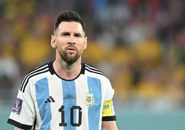 Messi  with a beard wearing a blue and white shirt