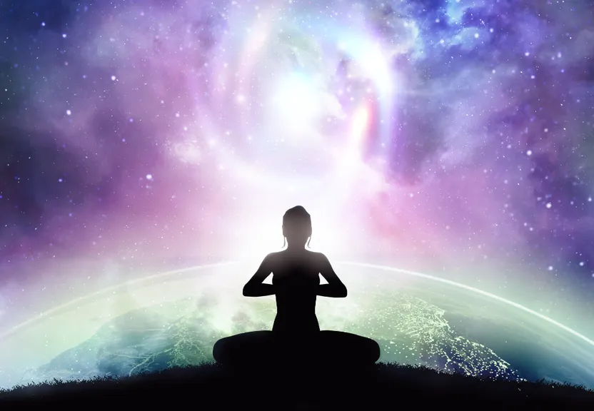 a person sitting in a yoga position in front of a galaxy background