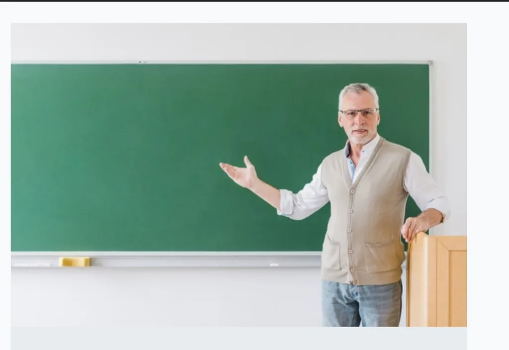 a man standing in front of a green chalk board