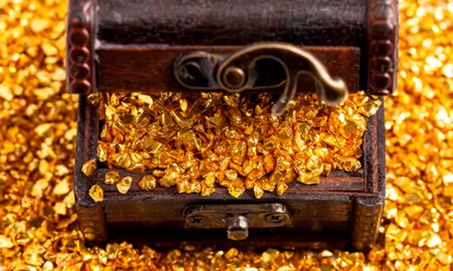 a wooden box filled with gold flakes