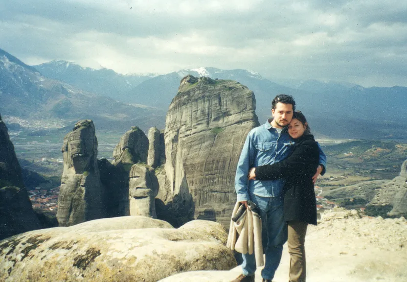 a man and a woman standing on top of a mountain