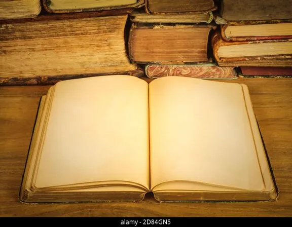 an open book sitting on top of a wooden table