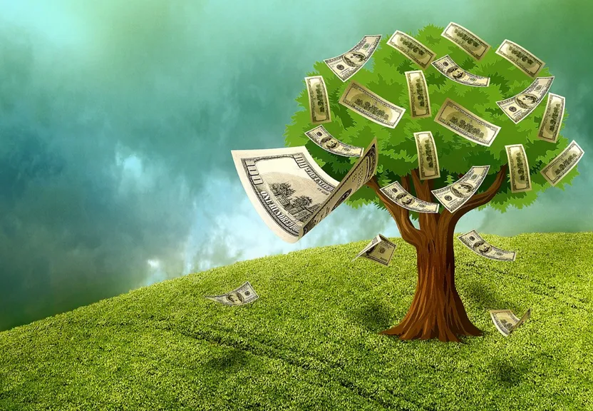 a tree with money falling from it on top of a hill