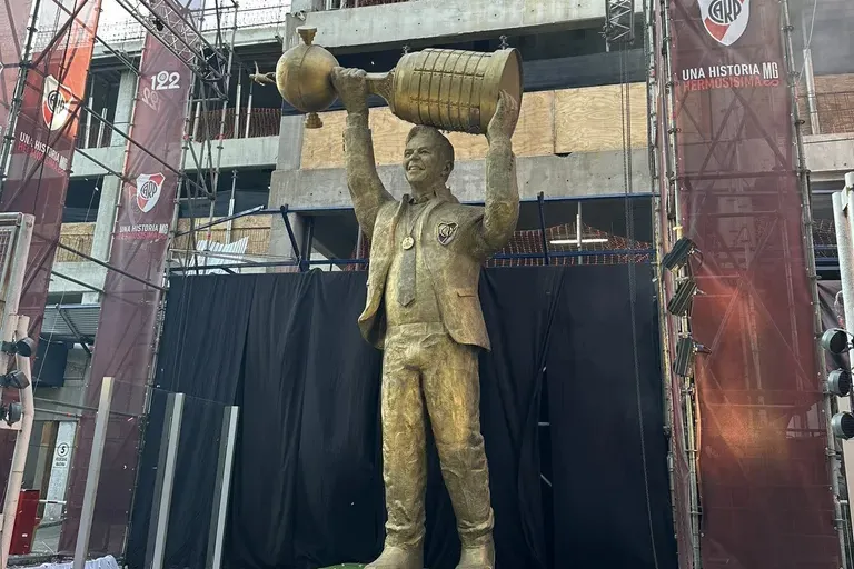a statue of a man holding a bucket over his head
