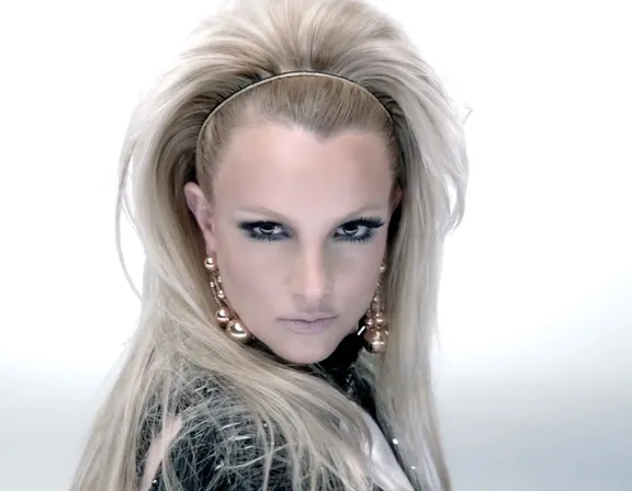 Highly detailed and hyper realistic Britney Spears in black outfit with beautiful intricate and detailed blonde hair, ultra detailed face and ultra realistic Smokey eyes and make-up, 8k octane render, cinematic, musicvideo, beauty shot, professional studio lighting, 