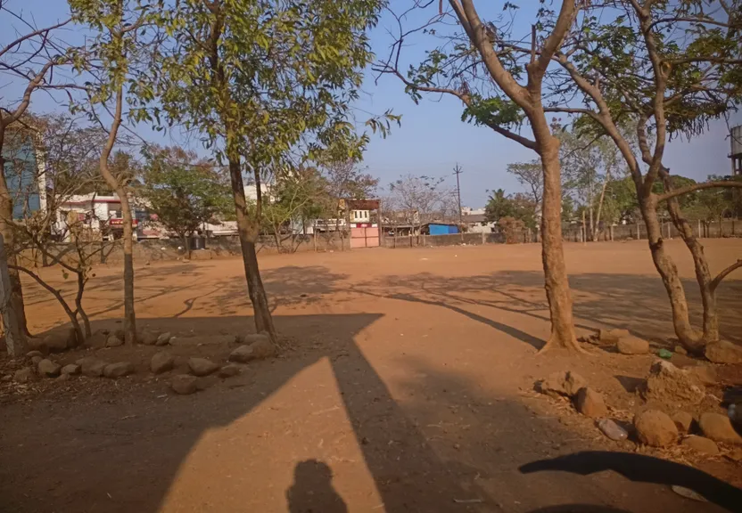 a shadow of a person on a dirt road