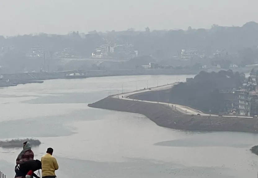 a couple of people standing on top of a hill