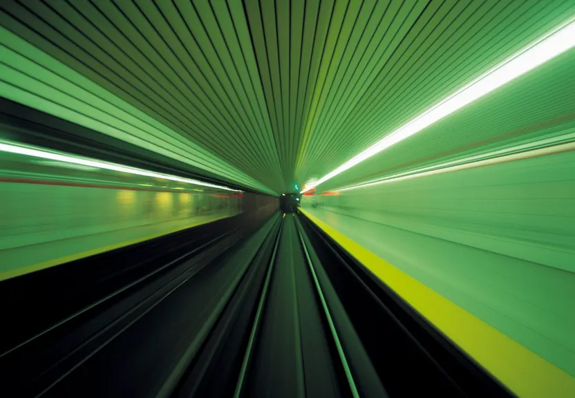 a blurry image of a train going through a tunnel