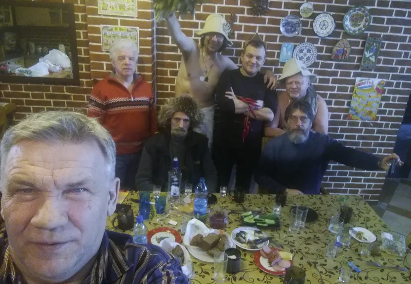 a group of people standing around a table