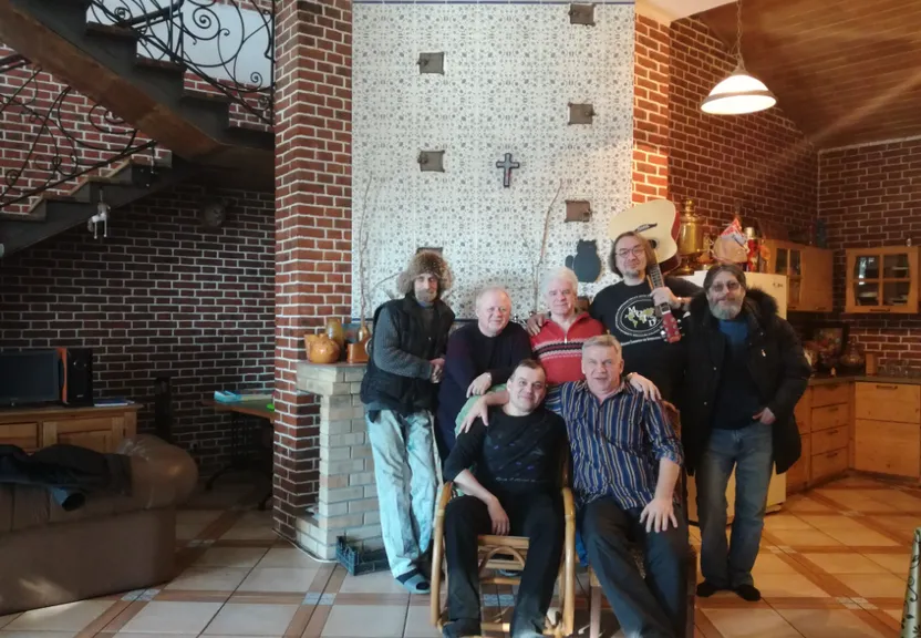 a group of people posing for a picture in a living room