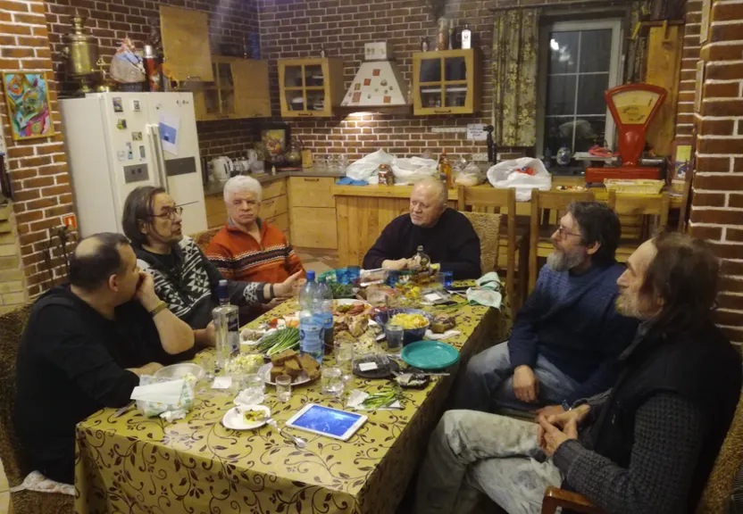 a group of people sitting around a table