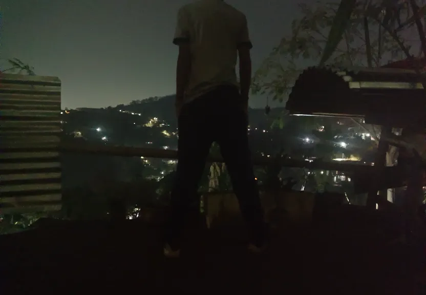 a man standing on top of a roof at night