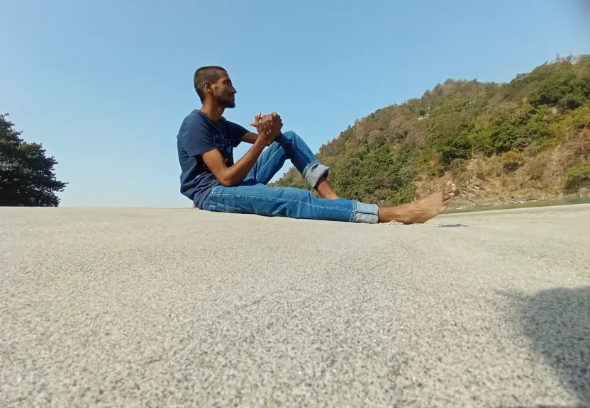 a man sitting on the side of a road