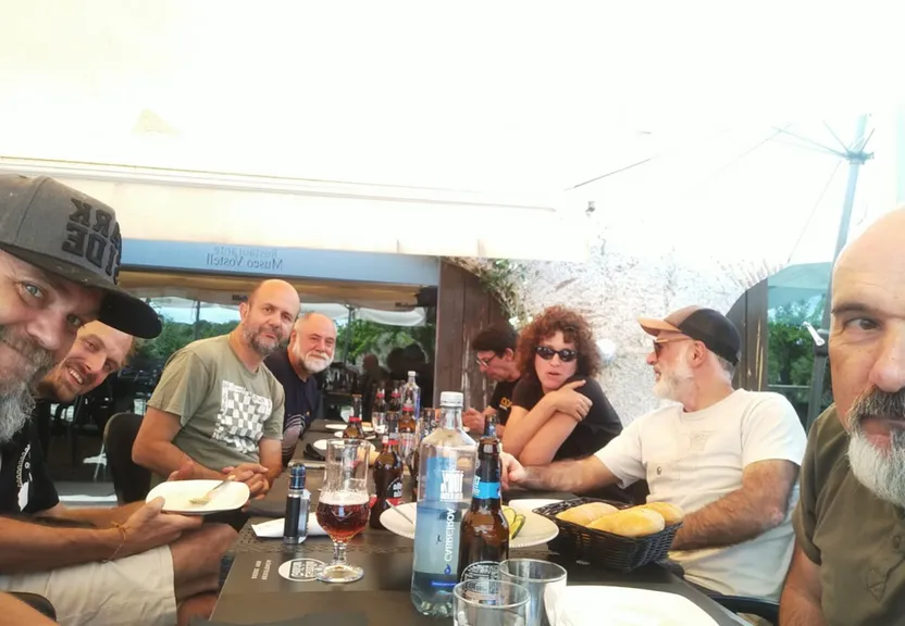 a group of people sitting around a table eating food