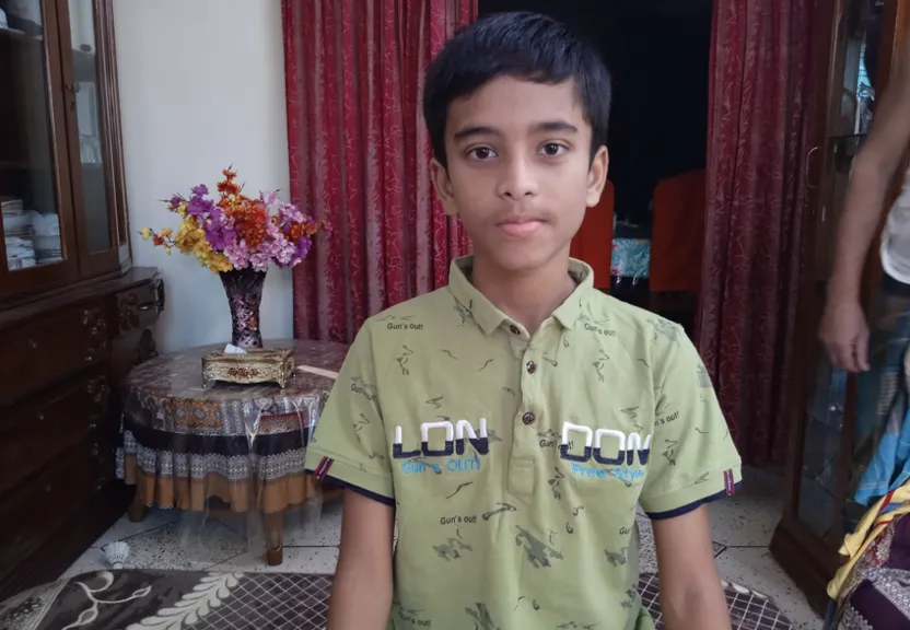 a young boy standing in front of a mirror