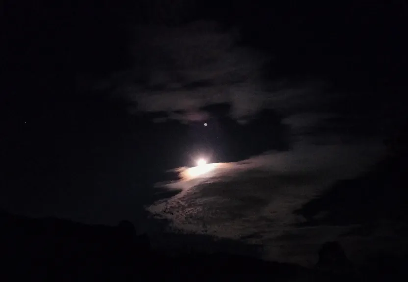 A Full Moon and Some Clouds in the Night Sky, with an Orange Moon Disc and a Purple Cloud Sky. have the moon be an orange disc with a pinkish hue, and the clouds be purple