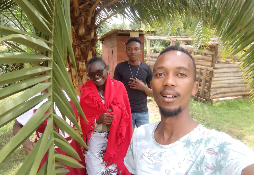 a group of people standing next to a palm tree
