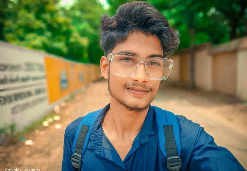 a man wearing glasses and a blue shirt