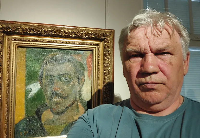 a man standing next to a painting of a man