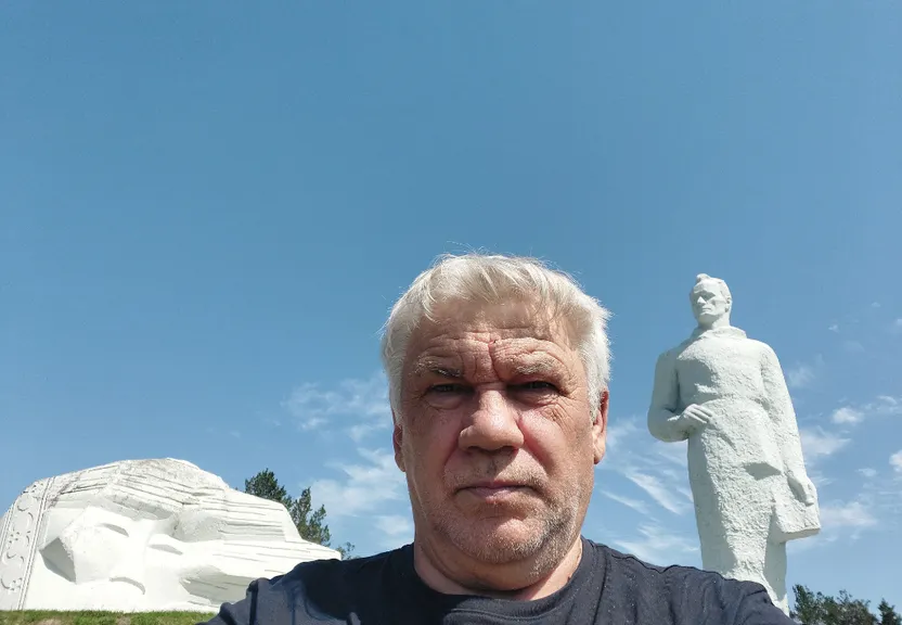 a man is standing in front of a statue