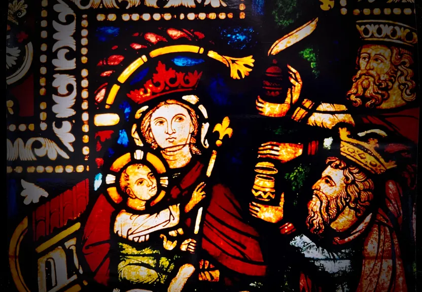 a stained glass window depicting a man holding a child