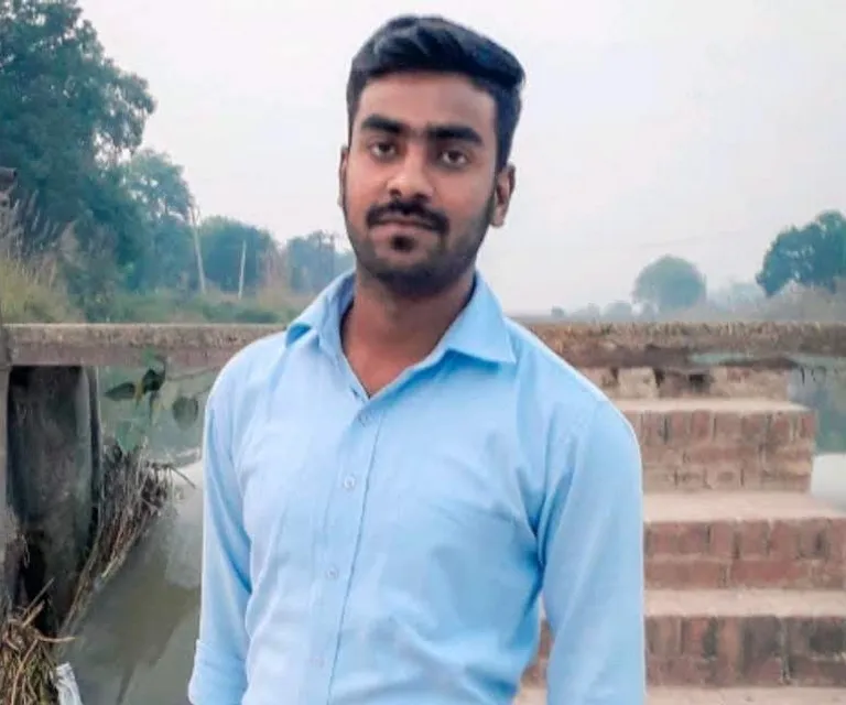 a man in a blue shirt standing in front of some steps