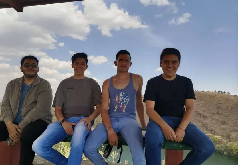 a group of young men sitting next to each other