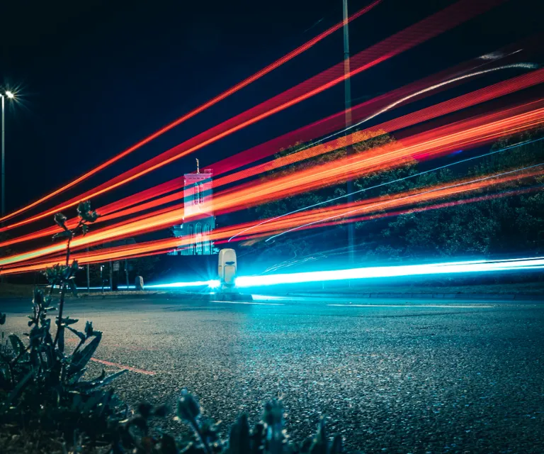 a long exposure photo of a street at night