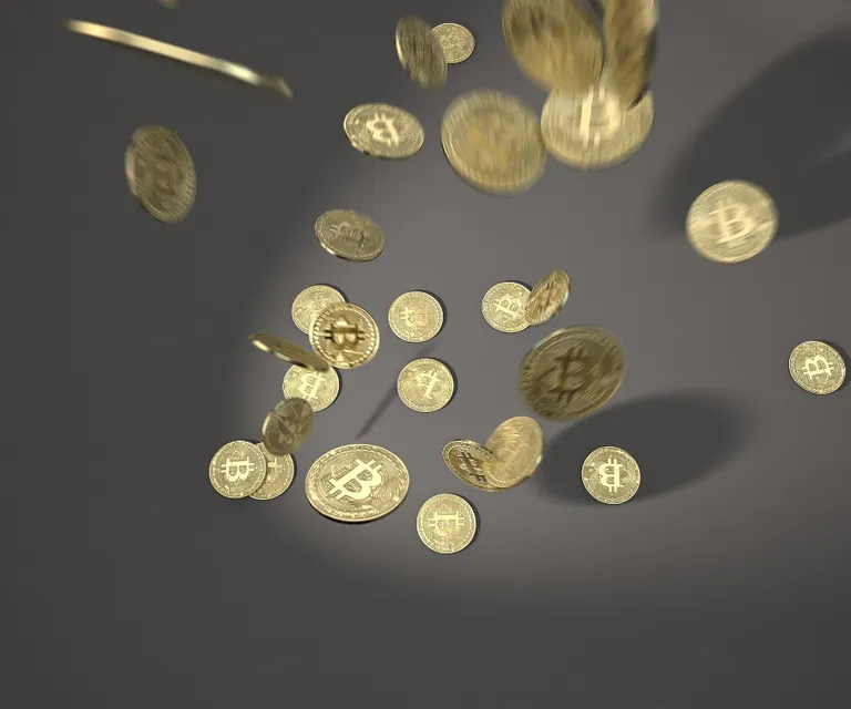 a bunch of gold coins falling into the air