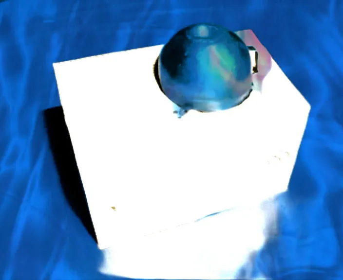 a blue ball is sitting on top of a white box