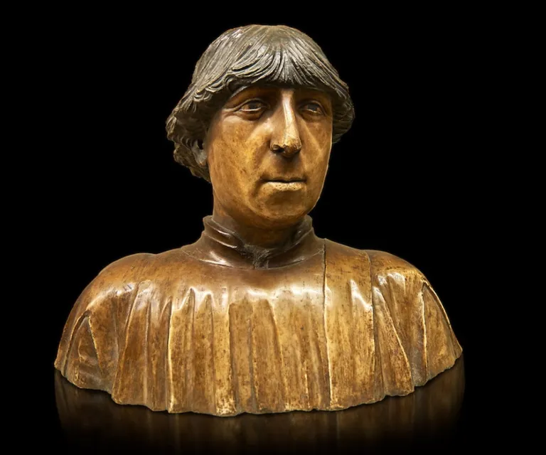 a wooden statue of a person with a black background