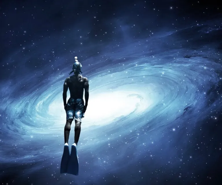 a man standing in front of a spiral galaxy