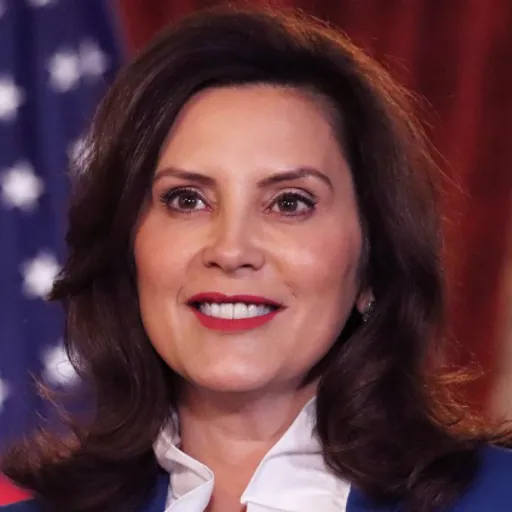 a close up of a person wearing a suit and tie