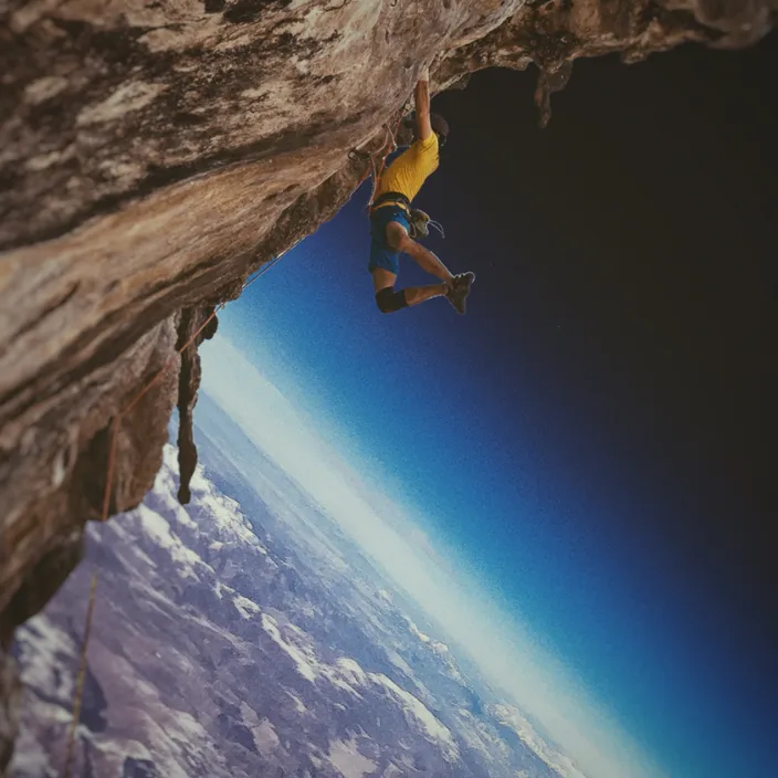 a man climbing up the side of a cliff