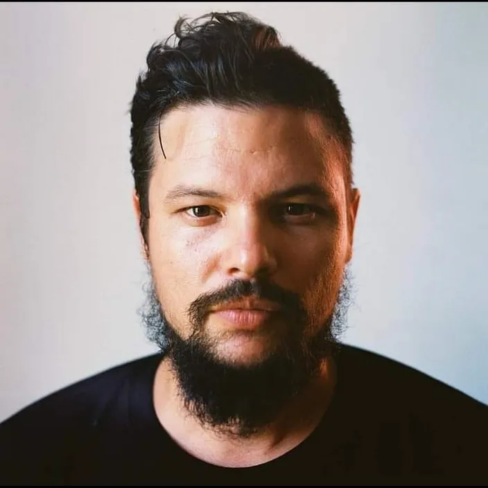 a close up of a person with a beard