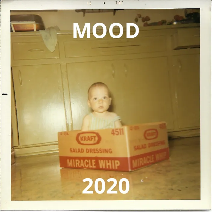 a baby sitting in a cardboard box with the words mood on it