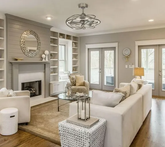 a living room filled with furniture and a fire place