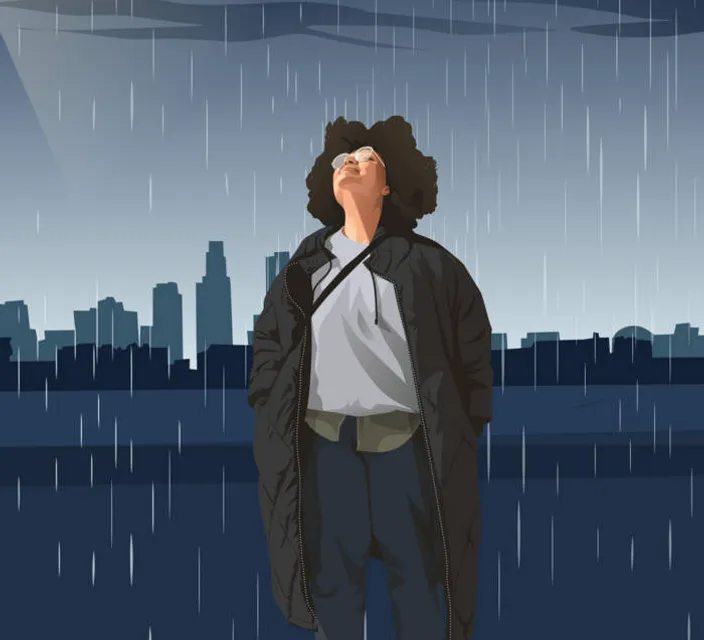 a man standing in the rain with his eyes closed