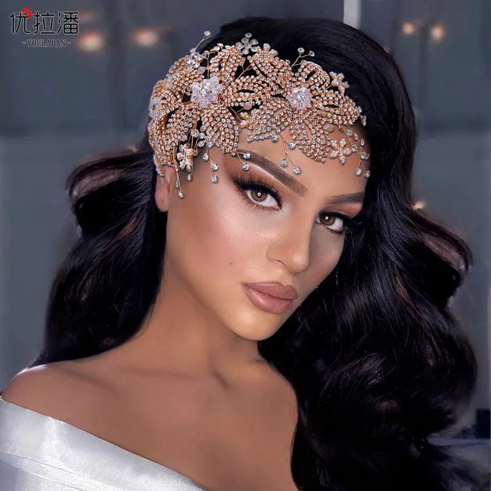 a woman in a white dress wearing a headpiece
