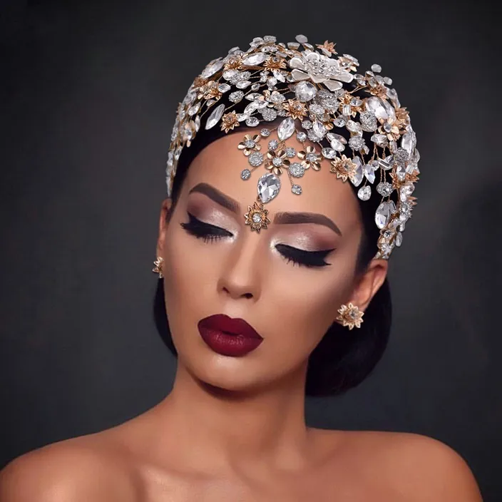 a woman wearing a headpiece with jewels on it