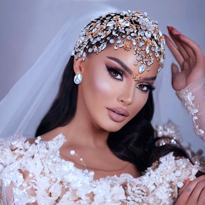 a woman in a wedding dress with a veil on her head