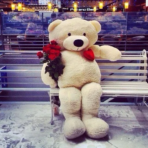 a large teddy bear sitting on a bench